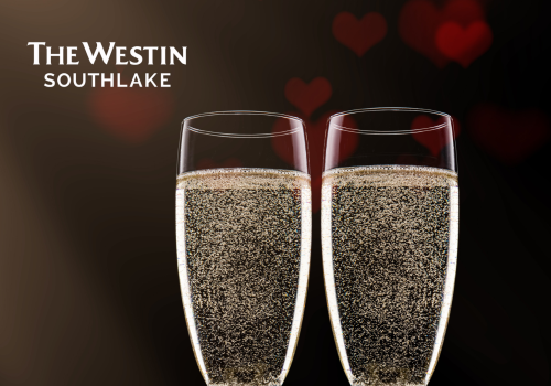 Two champagne flutes with bubbles, sitting on a red satin surface, a red rose beside them. The Westin Southlake logo is in the upper left corner.