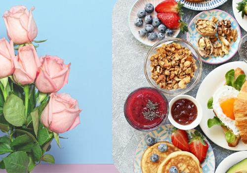 The image shows pink roses on the left and a breakfast spread on the right, featuring fruits, nuts, granola, pancakes, and a croissant with a runny egg.