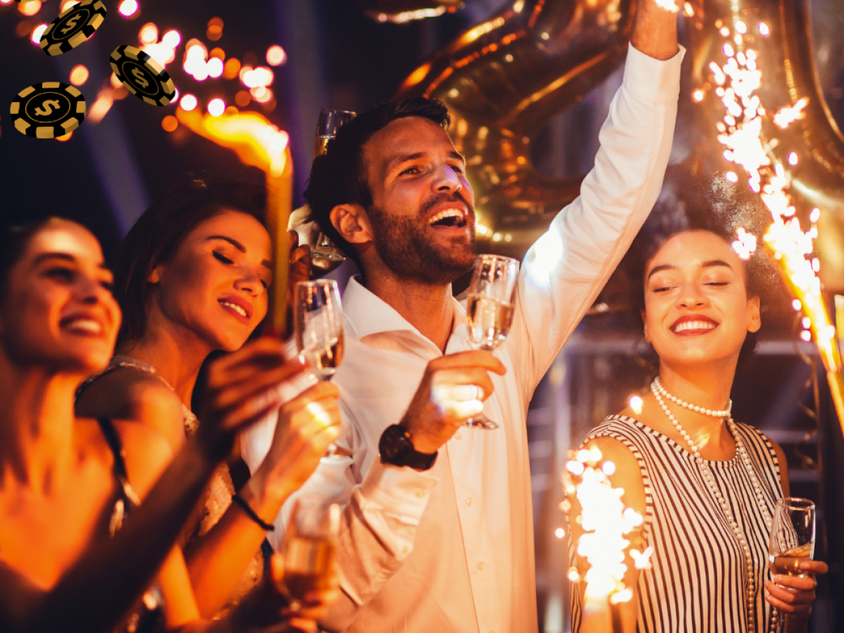 A group of people celebrating with sparklers and drinks in a festive setting, with poker chips and dollar symbols in the corner.